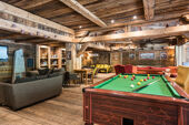 A communal sitting area and pool table at the Ferme du Val Claret