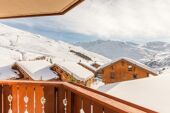 Sunny snowy mountain views from balcony at Les Alpages de Reberty Les Menuires